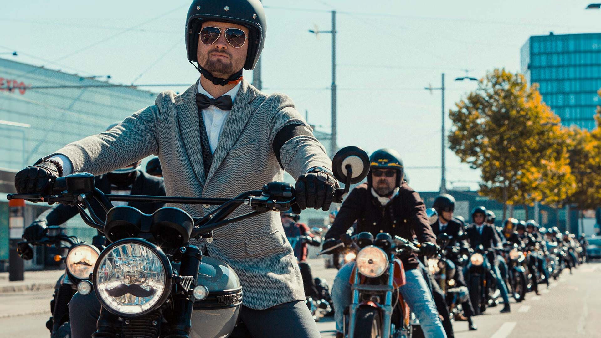 Photo of splendidly dressed, dapper motorcyclists riding at the Distinguished Gentleman's Ride.