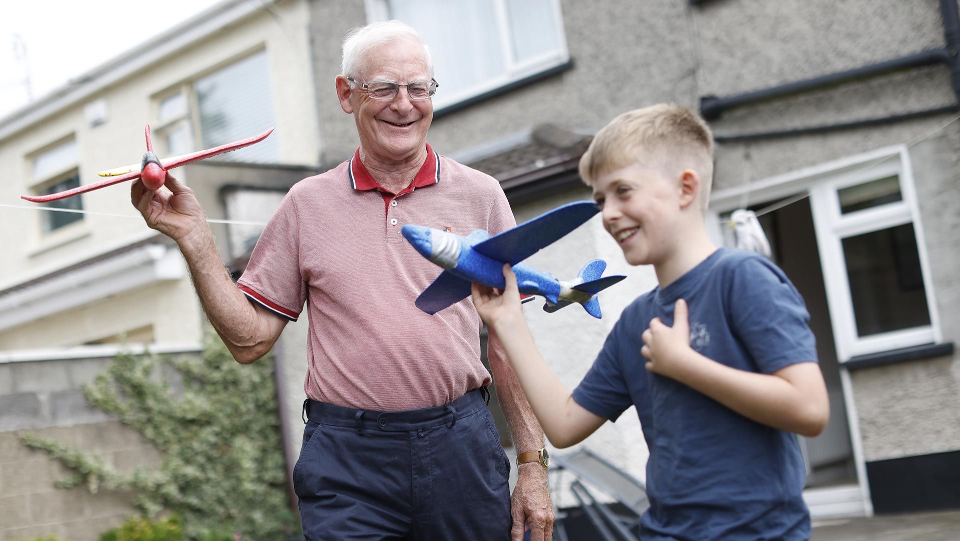 Photo of grandfather and grandson spending time together outdoors
