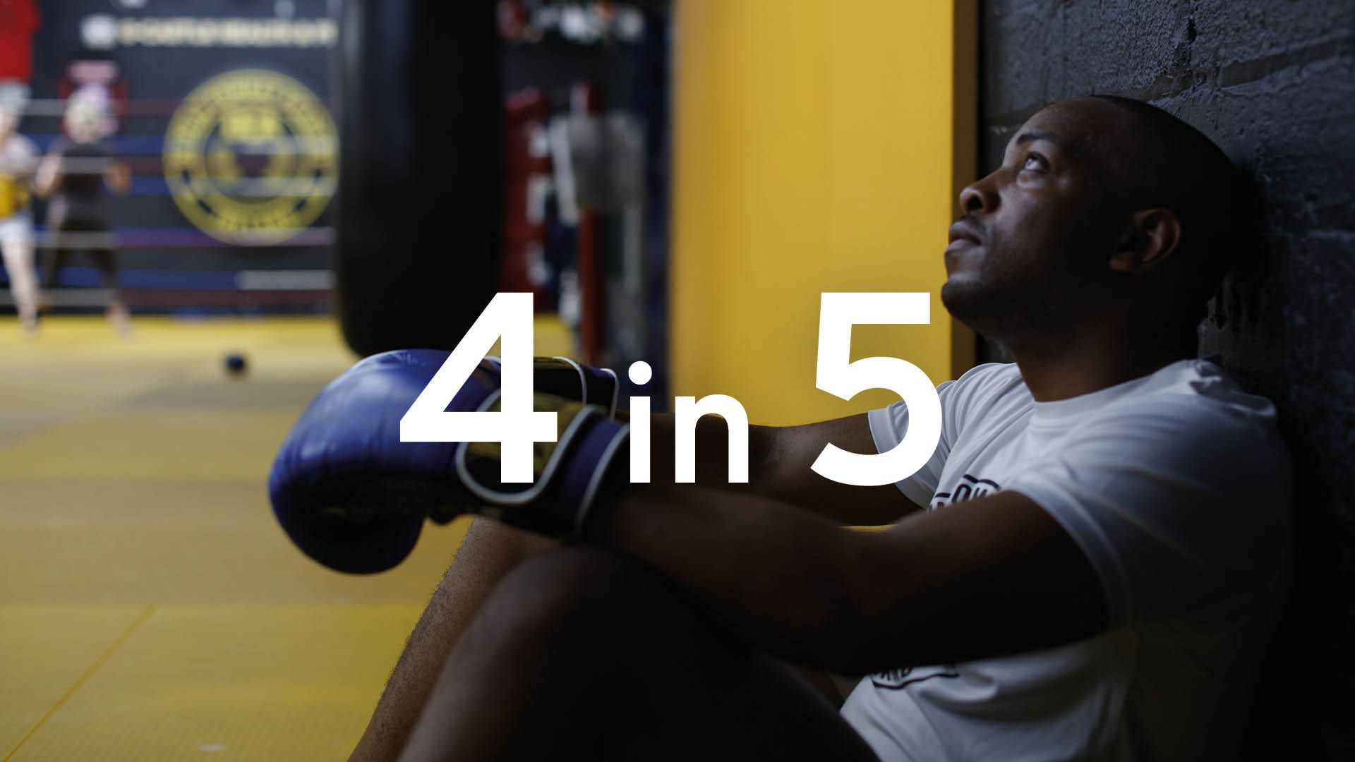 Photo of a young man in a boxing gym. Superimposed text says 4 in 5.