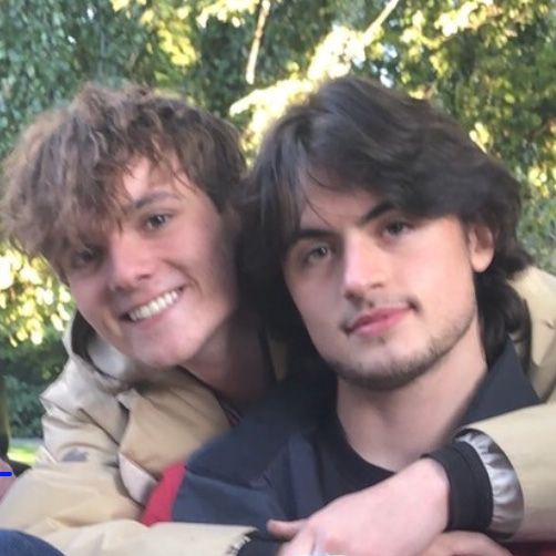 Two handsome young men, smiling to camera.