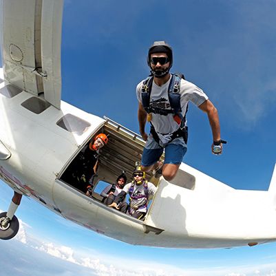 Photo of a skydiver leaping out of a plane