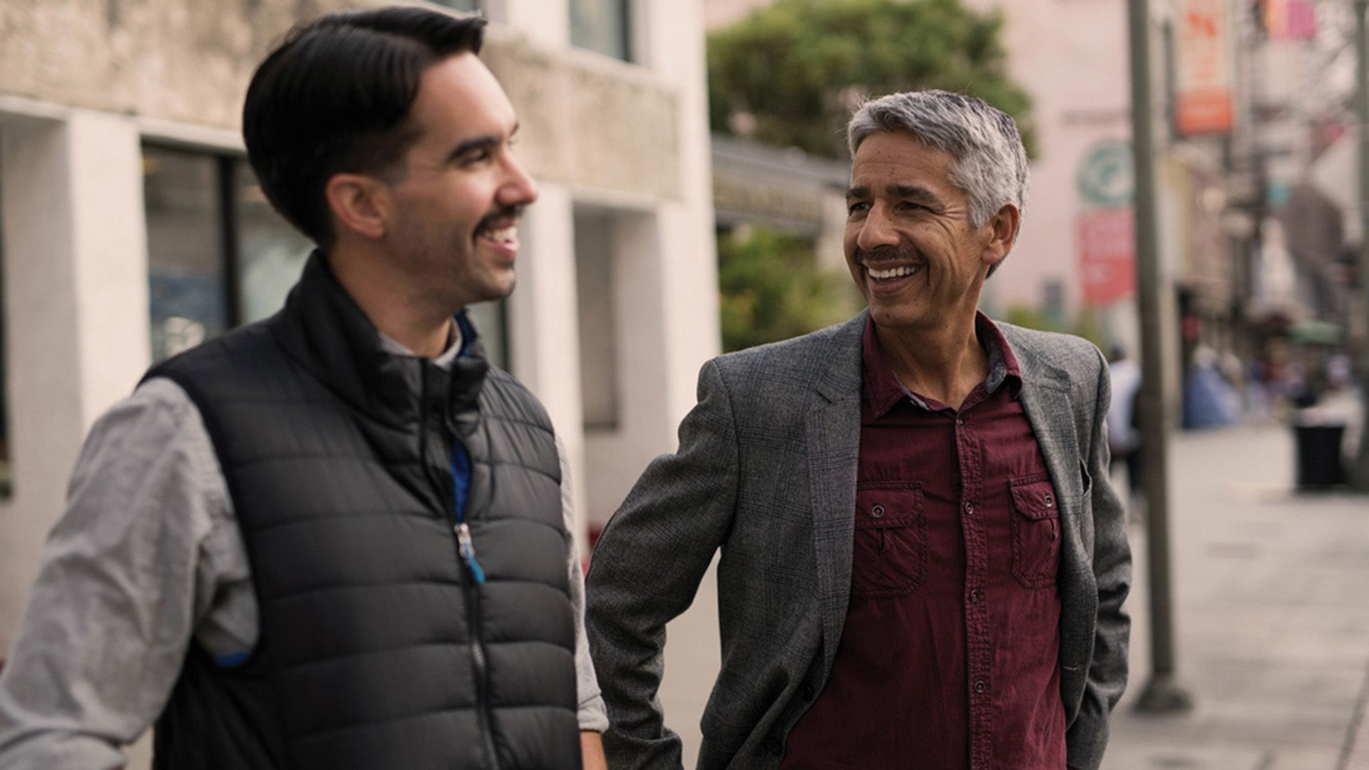 Photo of two men cheerfully chatting men.