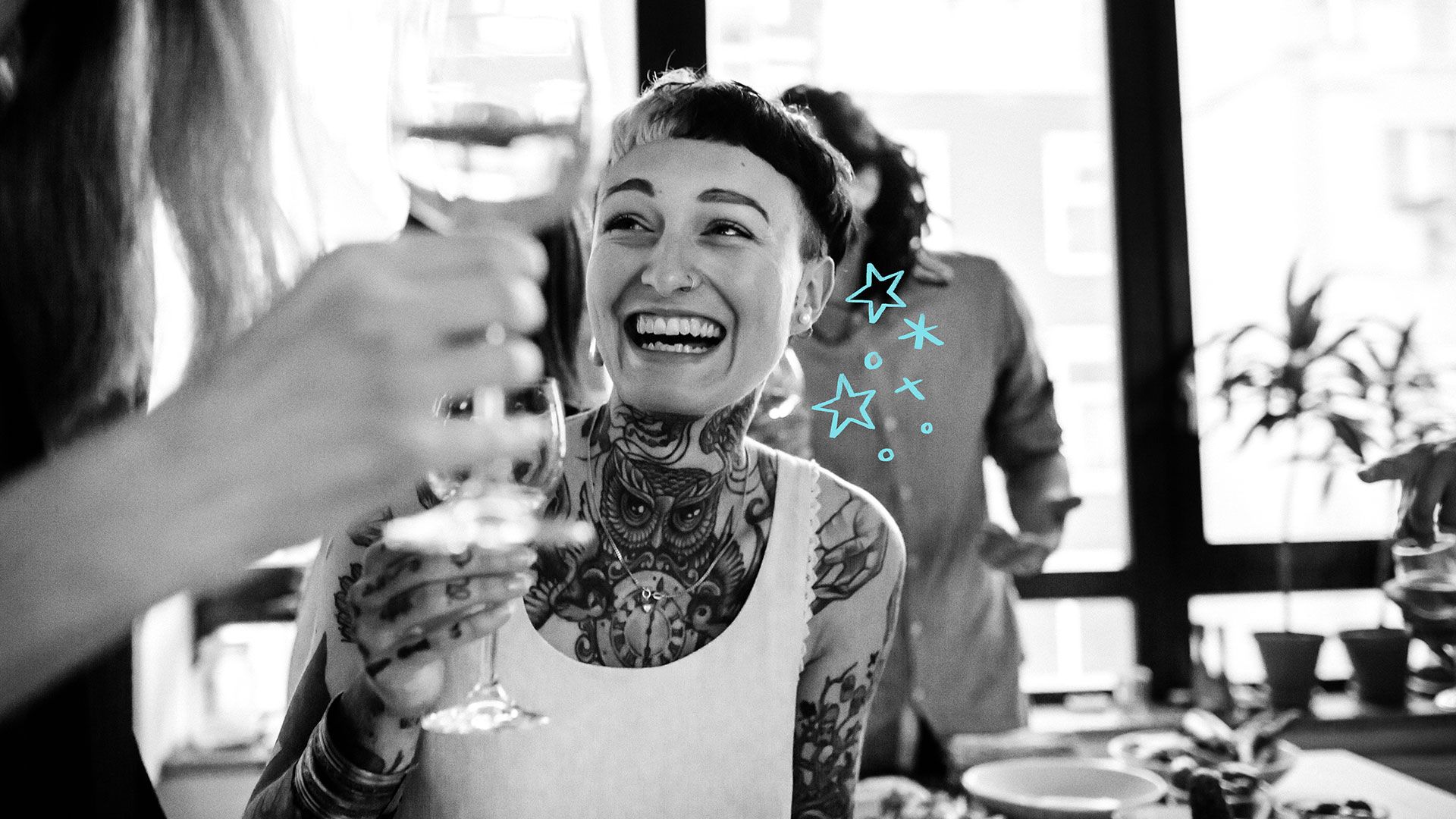 An image of a Mo Sister holding a wine glass and having a good time with a friend.